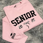 Pink sweatshirt with 'Senior 2025' text on a gray textured background